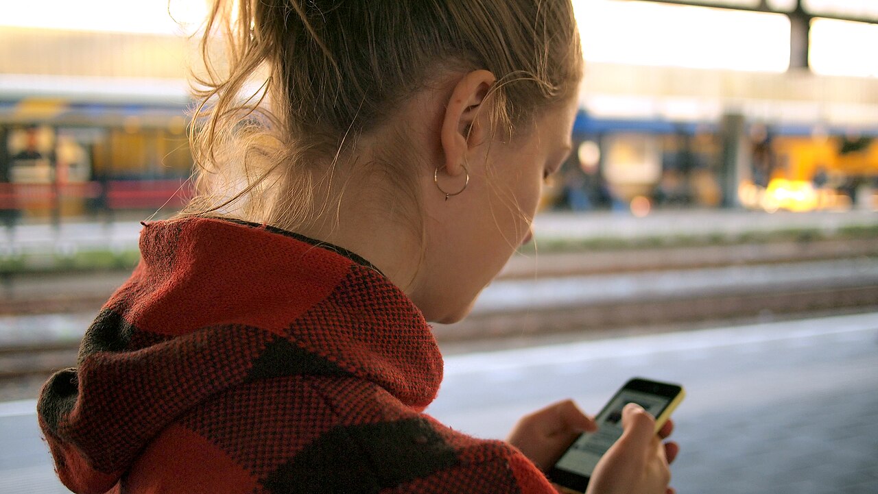 Person reviewing a suspicious transaction on their phone